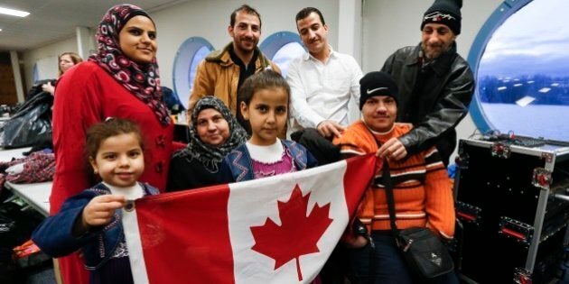 TORONTO, ON - DECEMBER 27: A Syrian refugee family, sponsored by a local group called Ripple Refugee Project, pose for photos. Lots are: Reemas Al Abdullah, 5 (little girl), Sawsan Al Samman (red coat), Nahla Al Abdullah (older lady), Aya Al Abdullah, 8 (girl), Anais Al Abdullah (brown coat), Mohamad Al Abdullah (white shirt), Oais Al Abdullah (orange sweater) and Abdullah Al Abdullah (black coat). Friends of Syria hosted a dinner for refugees at the Toronto Port Authority. (Bernard Weil/Toronto Star via Getty Images)