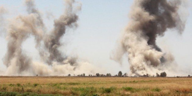 KIRKUK, IRAQ - AUGUST 17: Smoke rises after the air craft belonging to the US-led coalition bombed the areas according to the coordinates given by the Peshmerga forces in the village of Elbunecm, 44km south of Kirkuk, Iraq on August 17, 2015. The distance between Peshmerga forces and Daesh became 900m. (Photo by Hazar Rashd Hameed/Anadolu Agency/Getty Images)