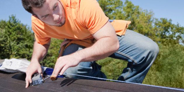 Man measuring with chalk dust on roof
