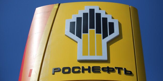 A logo sits on a sign outside an OAO Rosneft gas station in Moscow, Russia, on Friday, July 18, 2014. Russia's biggest oil company, natural gas producer OAO Novatek and OAO Gazprombank, the third-largest lender, are among those hit by the penalties, the U.S. Treasury Department said. Photographer: Andrey Rudakov/Bloomberg via Getty Images