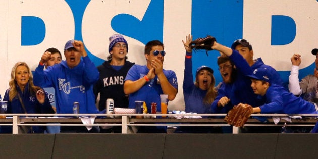 KANSAS CITY, MO - OCTOBER 23: (2nd R) Caleb Humphreys, 19, of Blue Springs, Missouri, cheers after catching a home run ball hit by Mike Moustakas #8 of the Kansas City Royals in the second inning against the Toronto Blue Jays in game six of the 2015 MLB American League Championship Series at Kauffman Stadium on October 23, 2015 in Kansas City, Missouri. (Photo by Jamie Squire/Getty Images)