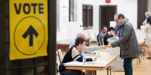 Voters cast ballots on election day in Toronto, Ontario, Canada, on Monday, Oct. 19, 2015. Canadians vote Monday in a tight federal election that polls suggest will bring Justin Trudeaus Liberal Party to power, ending the decade-long run of Prime Minister Stephen Harpers Conservatives. Photographer: James MacDonald/Bloomberg via Getty Images