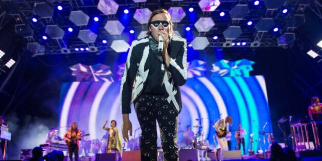 GLASTONBURY, ENGLAND - JUNE 27: Win Butler of Arcade Fire performs as the band headline the Pyramid Stage on Day 1 of the Glastonbury Festival at Worthy Farm on June 27, 2014 in Glastonbury, England. (Photo by Samir Hussein/Redferns via Getty Images)