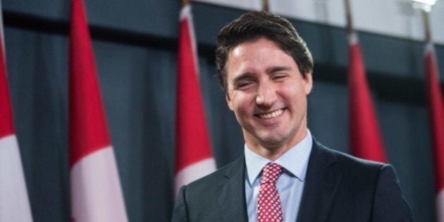 Canadian Liberal Party leader Justin Trudeau smiles at the end of a press conference in Ottawa on October 20, 2015 after winning the general elections. Liberal leader Justin Trudeau reached out to Canada's traditional allies after winning a landslide election mandate to change tack on global warming and return to the multilateralism sometimes shunned by his predecessor. AFP PHOTO/NICHOLAS KAMM (Photo credit should read NICHOLAS KAMM/AFP/Getty Images)