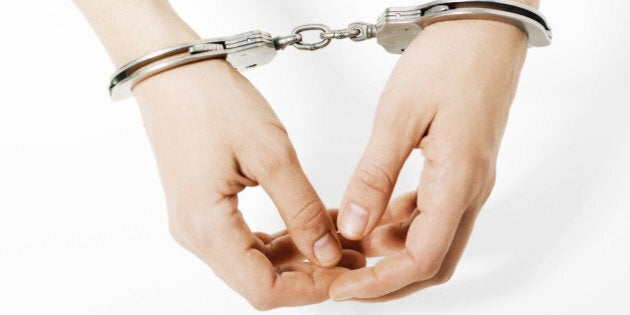 Handcuffed woman, close-up of hands