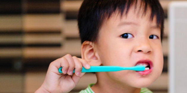 Little boy brushing his teeth.