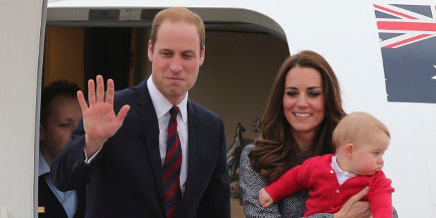 Britain's Prince William, left, and Kate, the Duchess of Cambridge, center, along with son Prince George, stand atop of the stairs to say good bye as they board their flight in Canberra, Australia, Friday, April 25, 2014. The Duke and Duchess concluded their three week state visit by attending the Anzac Day dawn service and parade, laying a wreath and planting a Lone Pine tree before departing for London with son Prince George.(AP Photo/Rob Griffith)