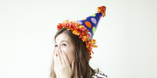 Studio shot of young woman wearing party hat