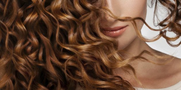 Beautiful young woman with long curly hairs