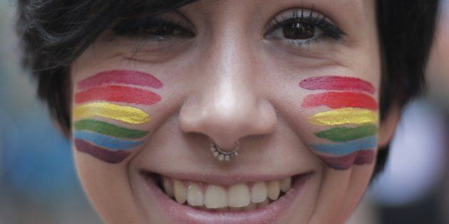 A girl with a 'rainbow' makeup takes part in the annual Lesbian, Gay, Bisexual and Transgender (LGBT) Pride Parade in Turin, on June 28, 2014. AFP PHOTO / MARCO BERTORELLO (Photo credit should read MARCO BERTORELLO/AFP/Getty Images)