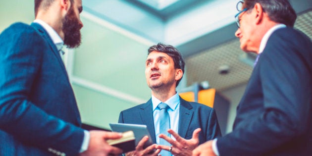 Group of business people in the office building lobby.