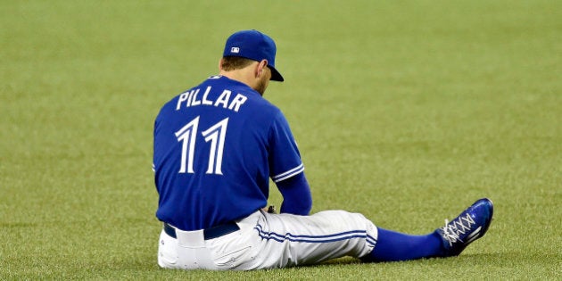 Toronto Blue Jays center fielder Kevin Pillar sits on the turf after hurting himself while trying to field a ball in the eighth inning against the Kansas City Royals during Game 4 of the ALCS on Tuesday, Oct. 20, 2015, at Rogers Centre in Toronto. (Jill Toyoshiba/Kansas City Star/TNS via Getty Images)