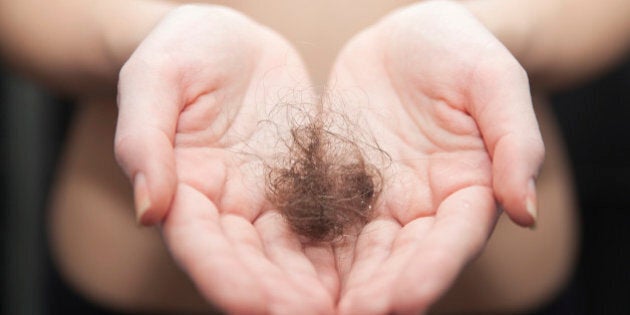 Close up of woman hands holding hair ball