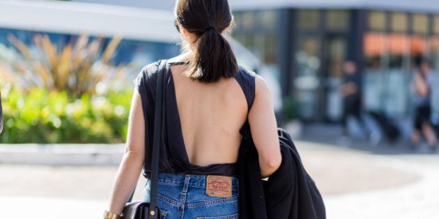 SYDNEY, AUSTRALIA - MAY 16: A guest wearing a backless top and Levis jeans outside Yeojin Bae at Mercedes-Benz Fashion Week Resort 17 Collections at Carriageworks on May 16, 2016 in Sydney, Australia. (Photo by Christian Vierig/WireImage)