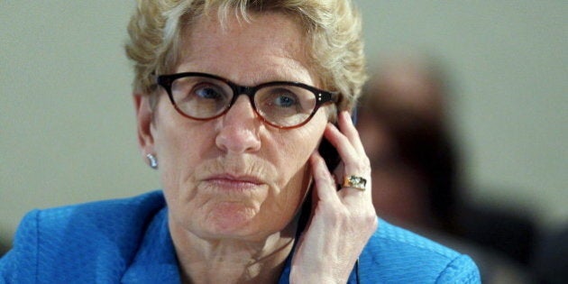 Ontario's Premier Kathleen Wynne listens to Quebec's Premier Philippe Couillard (not pictured) during the Quebec Summit On Climate Changes at the Hilton hotel in Quebec City, April 14, 2015. REUTERS/Mathieu Belanger