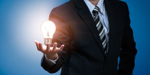 Light bulb in businessman's hand