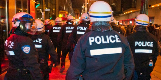 Police with riot gears patrol in downtown streets during student protesting against tuition hike in Montreal, Quebec, April 29, 2012. The Liberal Party of Quebec Premier Jean Charest, faced with a student protest movement that has turned violent, said Sunday it was relocating its annual convention to a city outside Montreal. AFP PHOTO / ROGERIO BARBOSA (Photo credit should read ROGERIO BARBOSA/AFP/GettyImages)