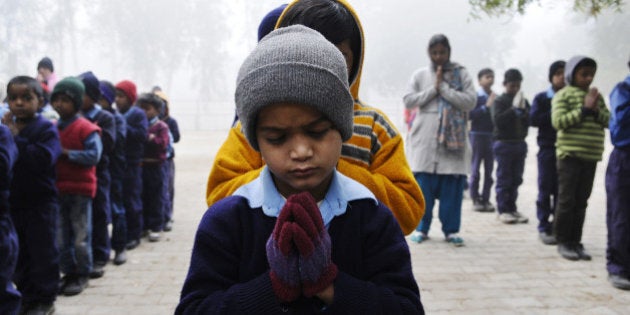 NEW DELHI, INDIA - DECEMBER 17: Students of Govt Primary School Village Pochanpur paying tribute to the victims of Peshawar school attack on December 17, 2014 in New Delhi, India. 141 people including 132 students and nine staff members were killed in a Taliban terror attack in Army-run school in Peshawar. (Photo by Vipin Kumar/Hindustan Times via Getty Images)