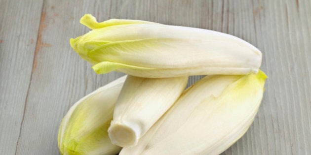 group of belgian endives on wooden table