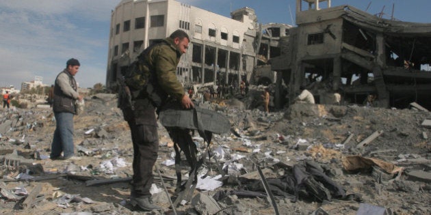 Palestinians check the damages of Hamas building destroyed by Israeli air strikes in Gaza.