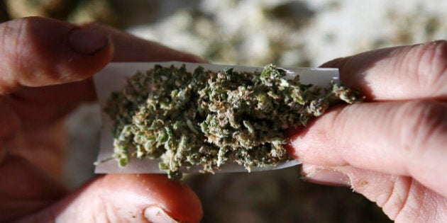 In this photo made Friday, Nov. 21, 2014, former U.S. Marine Sgt. Ryan Begin rolls a medical marijuana joint at his home in Belfast, Maine. The Pine Tree State might be high on marijuana in 2016, sparking a charge toward legalization that has previously been the province of western states. (AP Photo/Robert F. Bukaty)