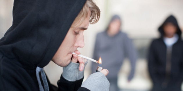 Man lighting marijuana cigarette