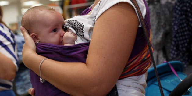 MADRID, SPAIN - AUGUST 23: A mother breast feeds her daughter during a protest at the entrance of a Primark Store on August 23, 2013 in Madrid, Spain. Nursing mothers organized breast feeding protest at Primark Stores across Spain to claim their right to breast feed children at anytime and at anywhere the child needs and stop the prejudice of doing it in public. Organizers say that on August 12, a woman was allegedly asked to leave a Primark Store as she was breast feeding her child. (Photo by Pablo Blazquez Dominguez/Getty Images)