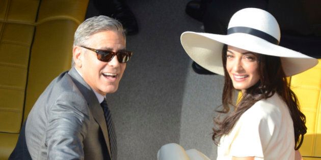 George Clooney and his wife Amal Alamuddin leave the city hall after their civil marriage ceremony in Venice, Italy, Monday, Sept. 29, 2014. George Clooney married human rights lawyer Amal Alamuddin Saturday, the actor's representative said, out of sight of pursuing paparazzi and adoring crowds. (AP Photo/Luigi Costantini)