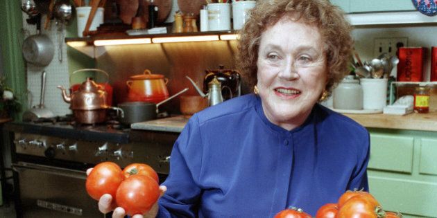 FILE - In this Aug. 13, 1992 file photo, chef and author Julia Child holds tomatoes in the kitchen at her home in Cambridge, Mass. More than a decade after her death, the foundation she created finally is launching a culinary award named in her honor. The Julia Child Award, which will be named annually, will be presented to someone who has improved how Americans think about food and cooking. The first winner will be announced in August 2015 and the award will be presented in October. (AP Photo/Jon Chase)