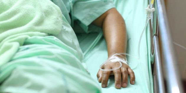 woman lying down in hospital bed