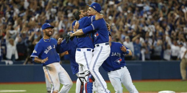 TORONTO, ON- OCTOBER 14: Roberto Osuna is embraced by catcher Dioner Navarro after recording the save. The Toronto Blue Jays and Texas Rangers play game five of the MLB American League Division Series . at Rogers Centre in Toronto. October 14, 2015. (Steve Russell/Toronto Star via Getty Images)