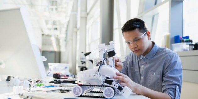 Focused engineer assembling robotic car