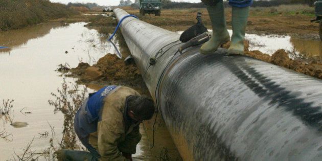 Bulgarian workers verify a gas pipeline under construction near the village of Sappes, north-east Greece, Tuesday, Nov. 21, 2006. The 285-kilometer (178-miles) link will deliver natural gas from central Asia to northeastern Greece and help diversify Europe's fuel imports by giving non-Russian gas its first direct western outlet. When finished, the 250 million (US$320 million) Turkey-Greece Interconnector will link the longtime Aegean rivals through a 36-inch (91-centimeter) pipeline running from the Turkish town of Karacabey to the northern Greek town of Komotini. The project will be completed by the end of 2006. (AP Photo/Nikolas Giakoumidis)