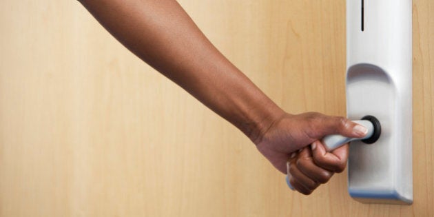 Businesswoman Opening Office Door