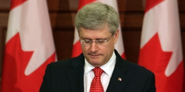 Prime minister Stephen Harper speaks to his caucus on Parliament Hill, in Ottawa, Tuesday May 21, 2013. (AP PHOTO/THE CANADIAN PRESS/Fred Chartrand)