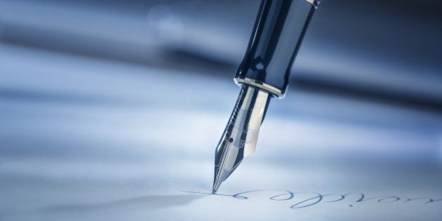 Signing a legal document with a fountain pen.