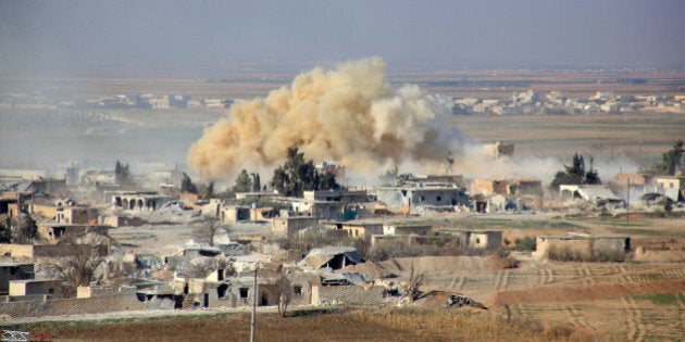 Smoke rises from buildings in the area of Tal Sharba following government air strikes on the outskirts of the northern Syrian city of Aleppo on December 27, 2015, as government forces seized the area from Islamic State (IS) group jihadists. AFP PHOTO / GEORGE OURFALIAN / AFP / GEORGE OURFALIAN (Photo credit should read GEORGE OURFALIAN/AFP/Getty Images)