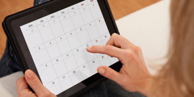 USA, Illinois, Metamora, Close-up of woman using calendar on digital tablet