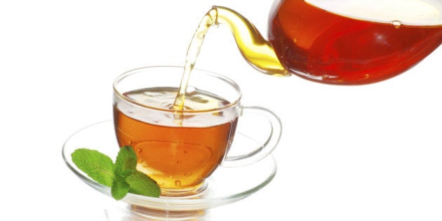 Tea being poured into glass tea cup