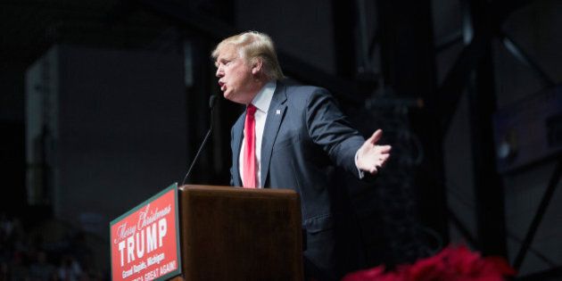GRAND RAPIDS, MI - DECEMBER 21: Republican presidential candidate Donald Trump speaks to guests at a campaign rally on December 21, 2015 in Grand Rapids, Michigan. The full-house event was repeatedly interrupted by protestors. Trump continues to lead the most polls in the race for the Republican nomination for president. (Photo by Scott Olson/Getty Images)