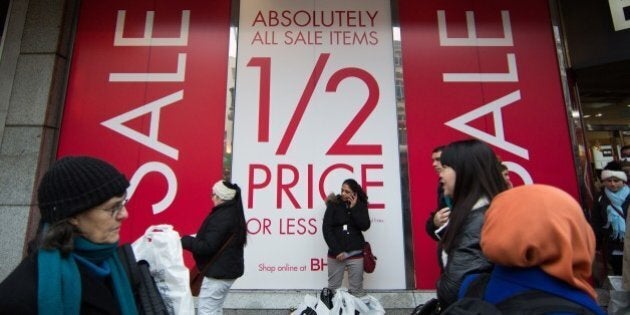 Shoppers walk along Oxford Street to find bargains in central London, on December 26, 2014, in the post...