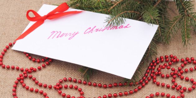 Christmas card with bow on a brown background.