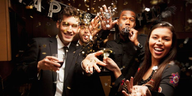 Friends drinking in kitchen at New Year's Eve party