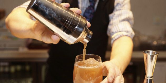 Bartender is making cocktail at bar counter