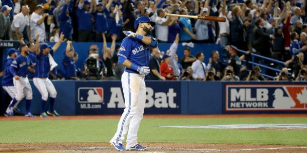 TORONTO, ON - OCTOBER 14: Jose Bautista #19 of the Toronto Blue Jays flips his bat up in the air after he hits a three-run home run in the seventh inning against the Texas Rangers in game five of the American League Division Series at Rogers Centre on October 14, 2015 in Toronto, Canada. (Photo by Tom Szczerbowski/Getty Images)