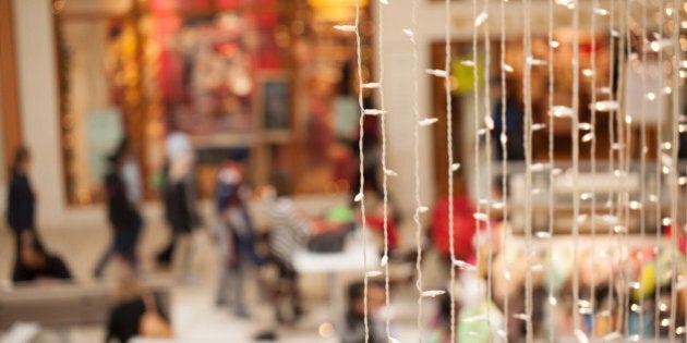 People going shopping in a mall decorated for Christmas