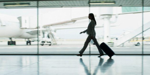 Businesswoman with suitcase in airport
