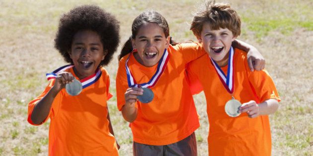 Group of multi-ethnic children (9 to 11 years) with medals.