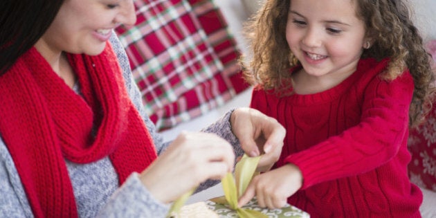 Mother and daughter wrapping present together