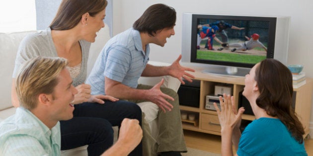 Friends watching baseball game and cheering